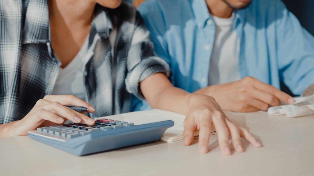 casal a fazer as contas para perceber se compensa mais entregar o IRS em conjunto ou em separado